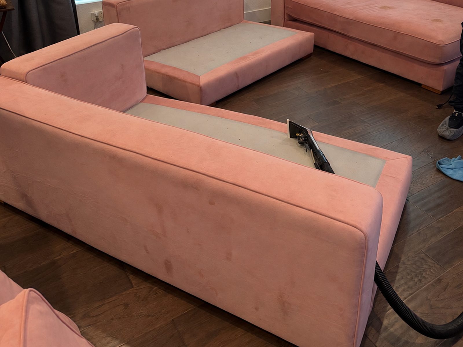 Before: pink velvet sectional with visible spots on the cushions and base