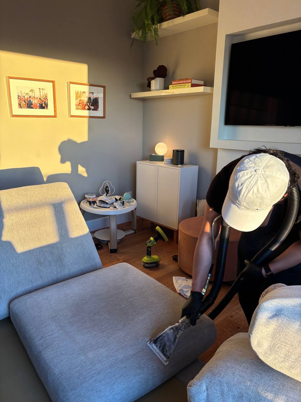 LOOMA technician in a white cap performing professional upholstery extraction